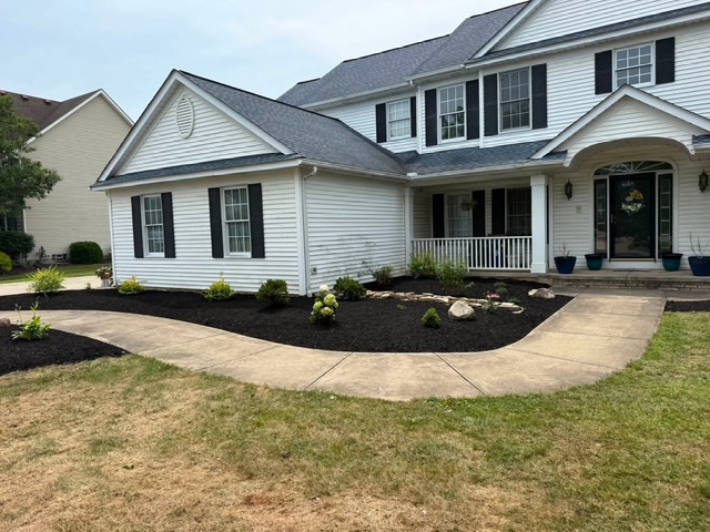 Front yard bed after landscape cleanup, plantings, and fresh mulch